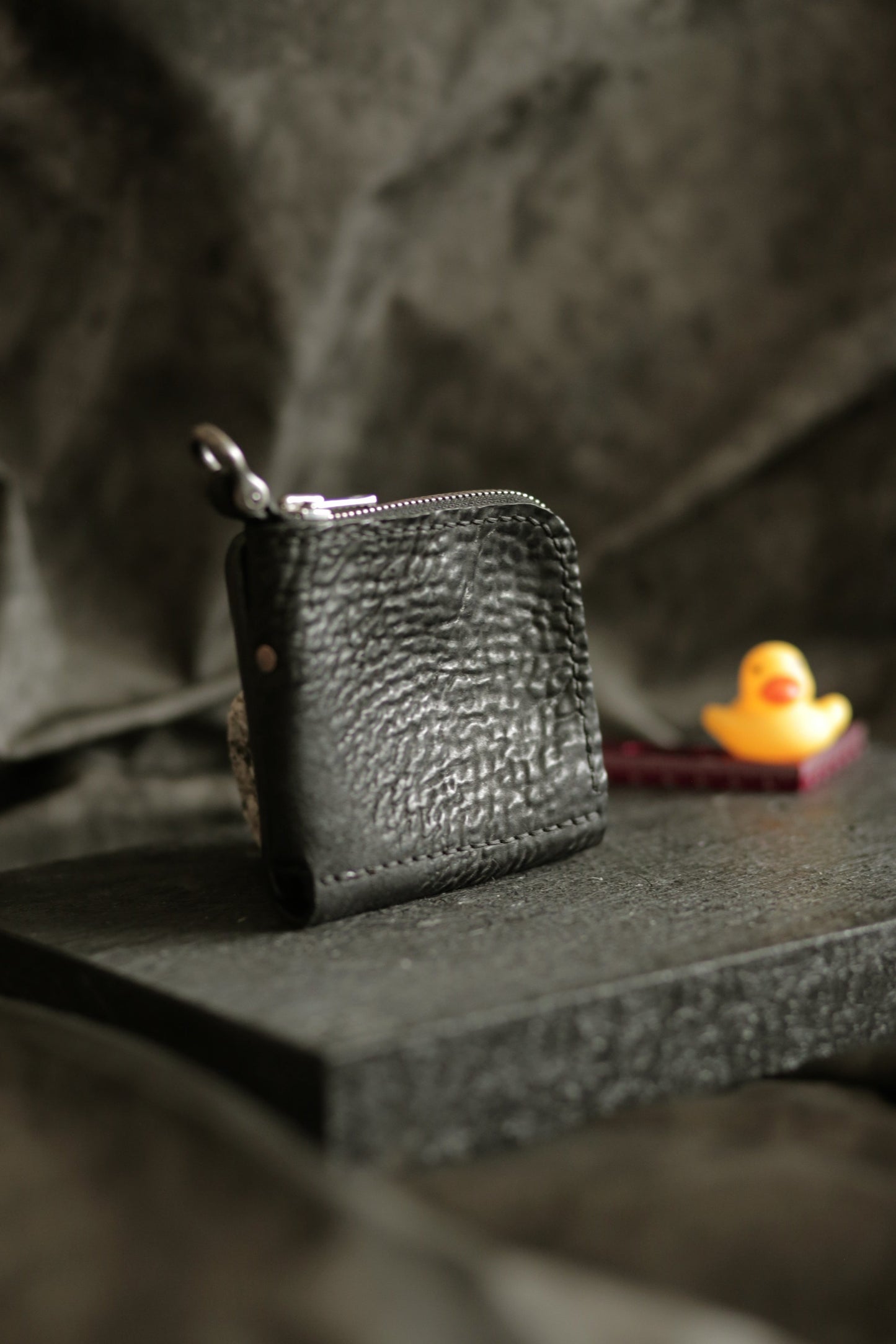 Boddin #007 compact handmade black wallet with unique textured veg tan reverse horse leather and zipper pouch.