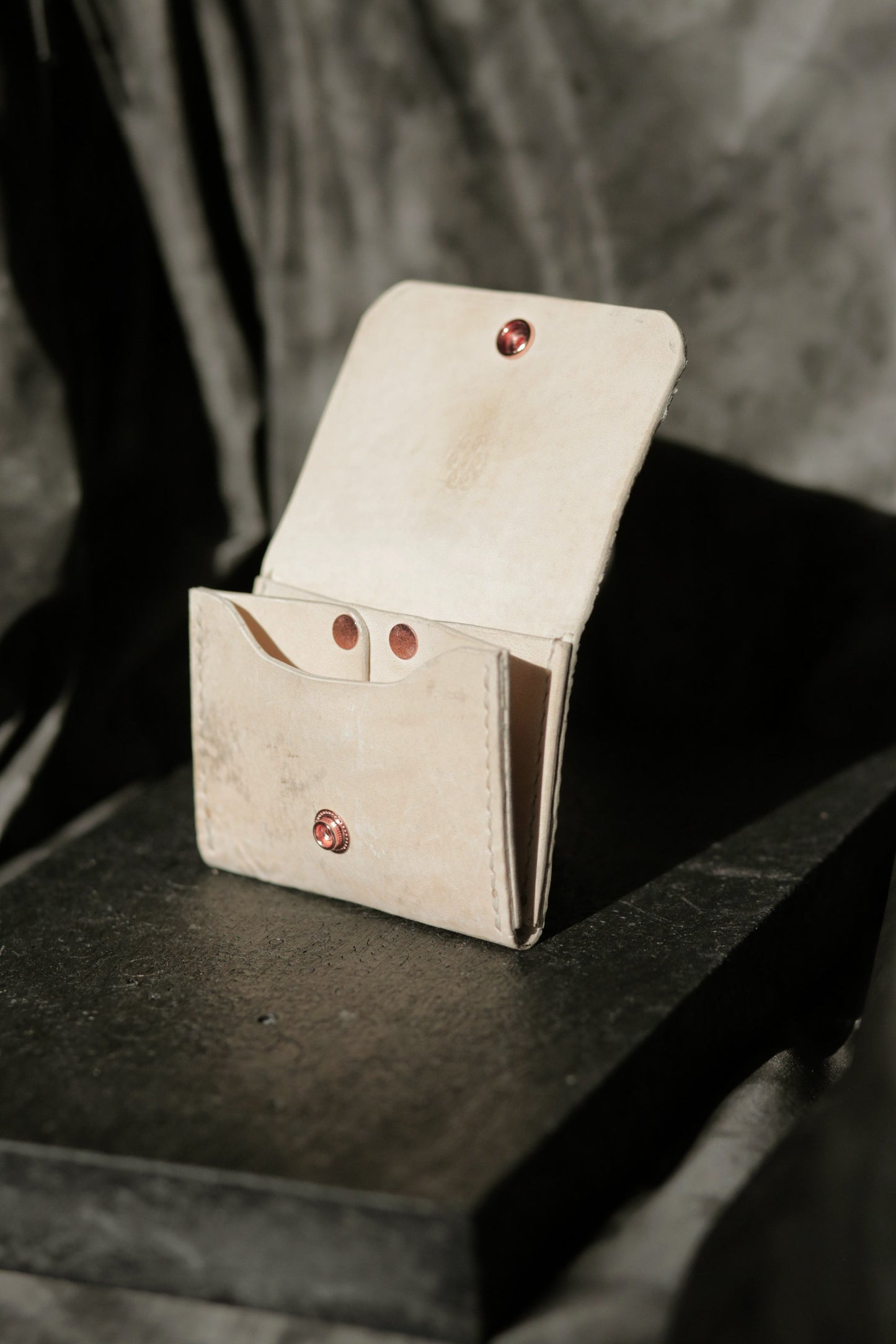 Hermann minimal snap wallet in dirty white reverse horse culatta leather with copper snap and rivet details.