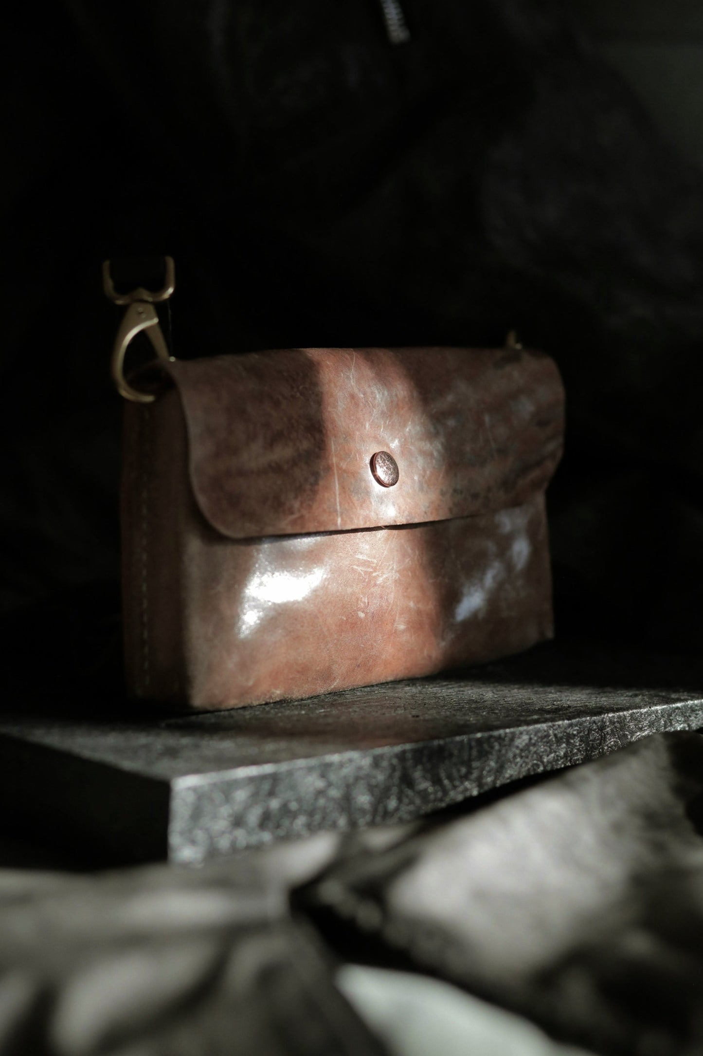 Köpenicker #002 prototype clutch in natural skin with brass hardware and soft horse shoulder leather strap.
