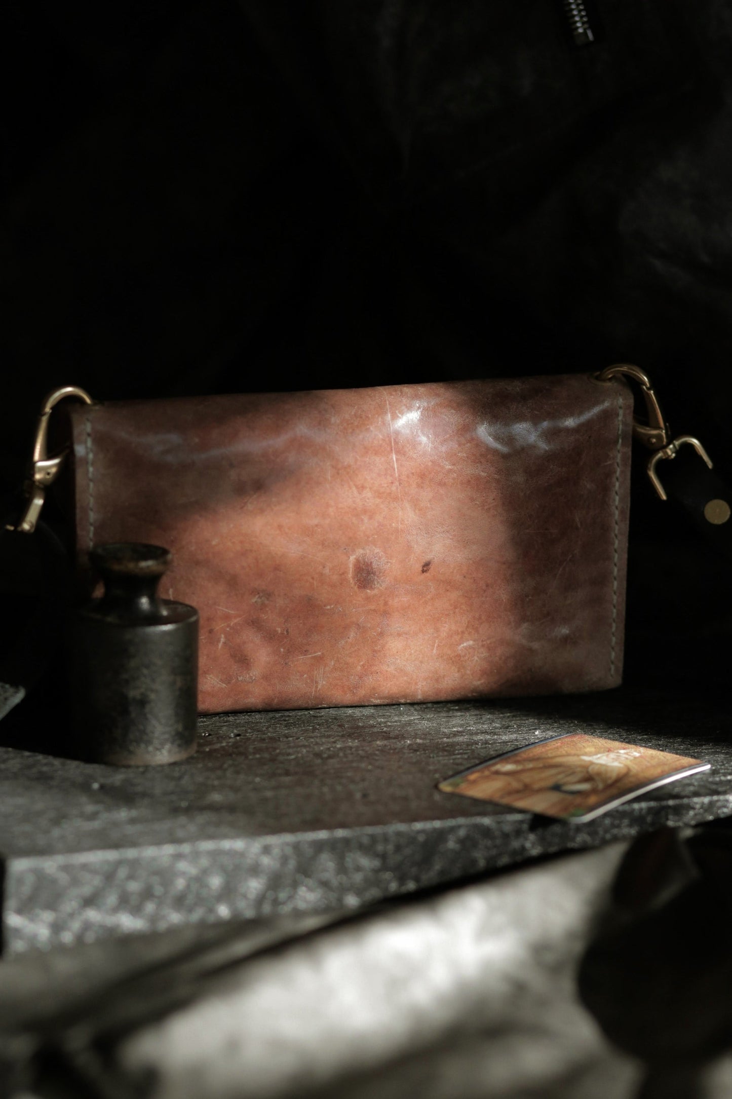 Köpenicker #002 prototype clutch in natural shell cordovan leather with brass hardware and adjustable soft shoulder strap.