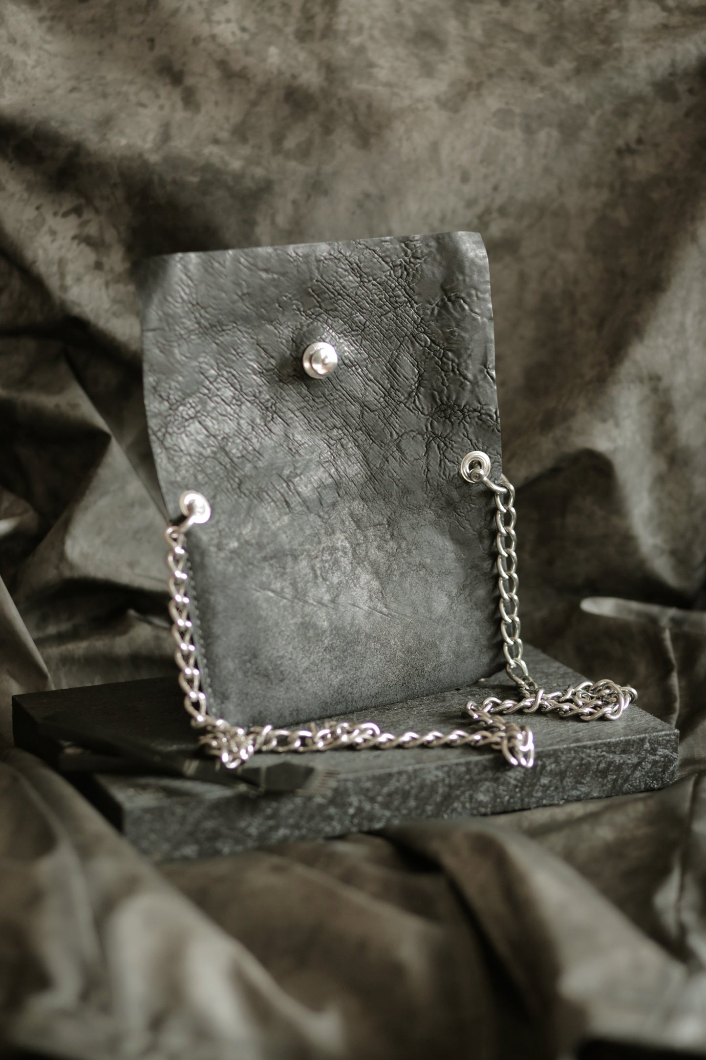 Köpenicker #004 leather clutch with polished 304 steel strap and secure Loxx lock for party essentials storage.
