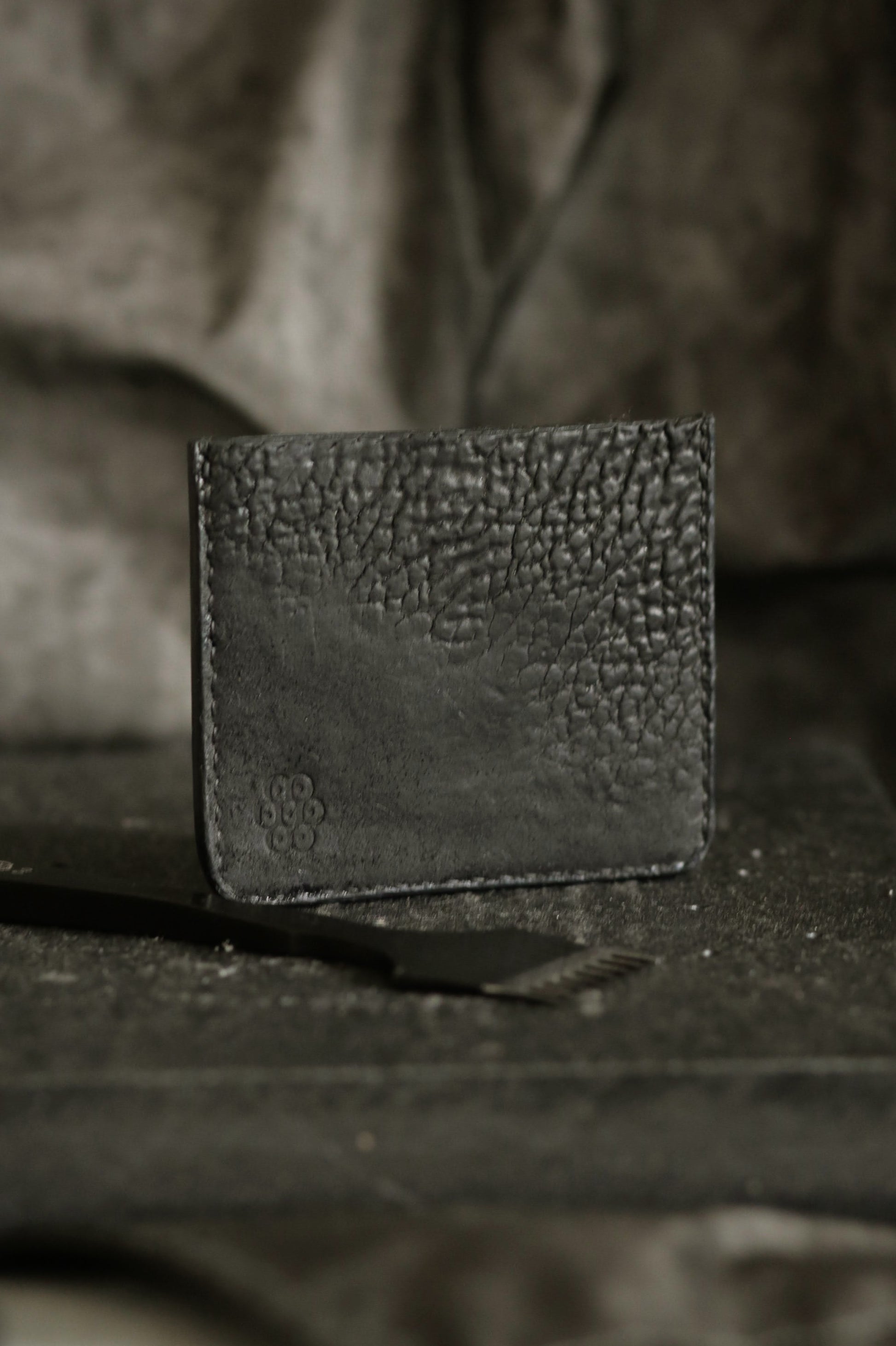 Schönlein #002 (sample) black culatta card holder made from recycled leather parts with textured surface and polished edges.