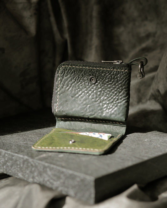 Boddin #008 new prototype handmade green leather wallet with zipper pouch and snap button on stone surface.