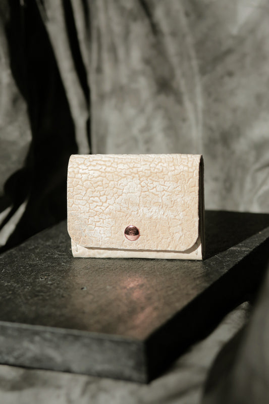 Hermann minimal snap wallet in dirty white reverse horse culatta leather with copper snap and rivets.