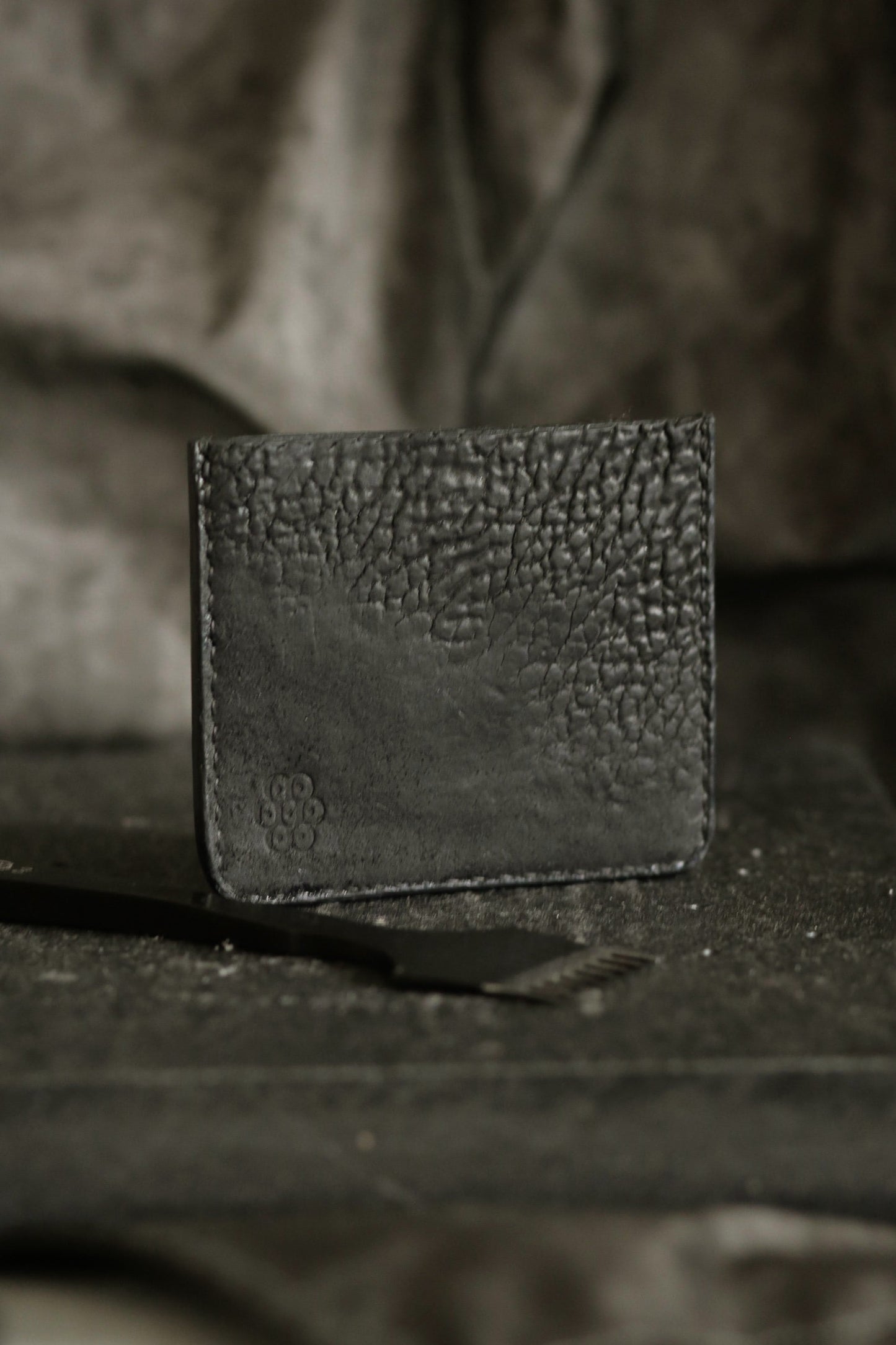 Schönlein #002 (sample) black culatta card holder made from recycled leather parts with textured surface and polished edges.