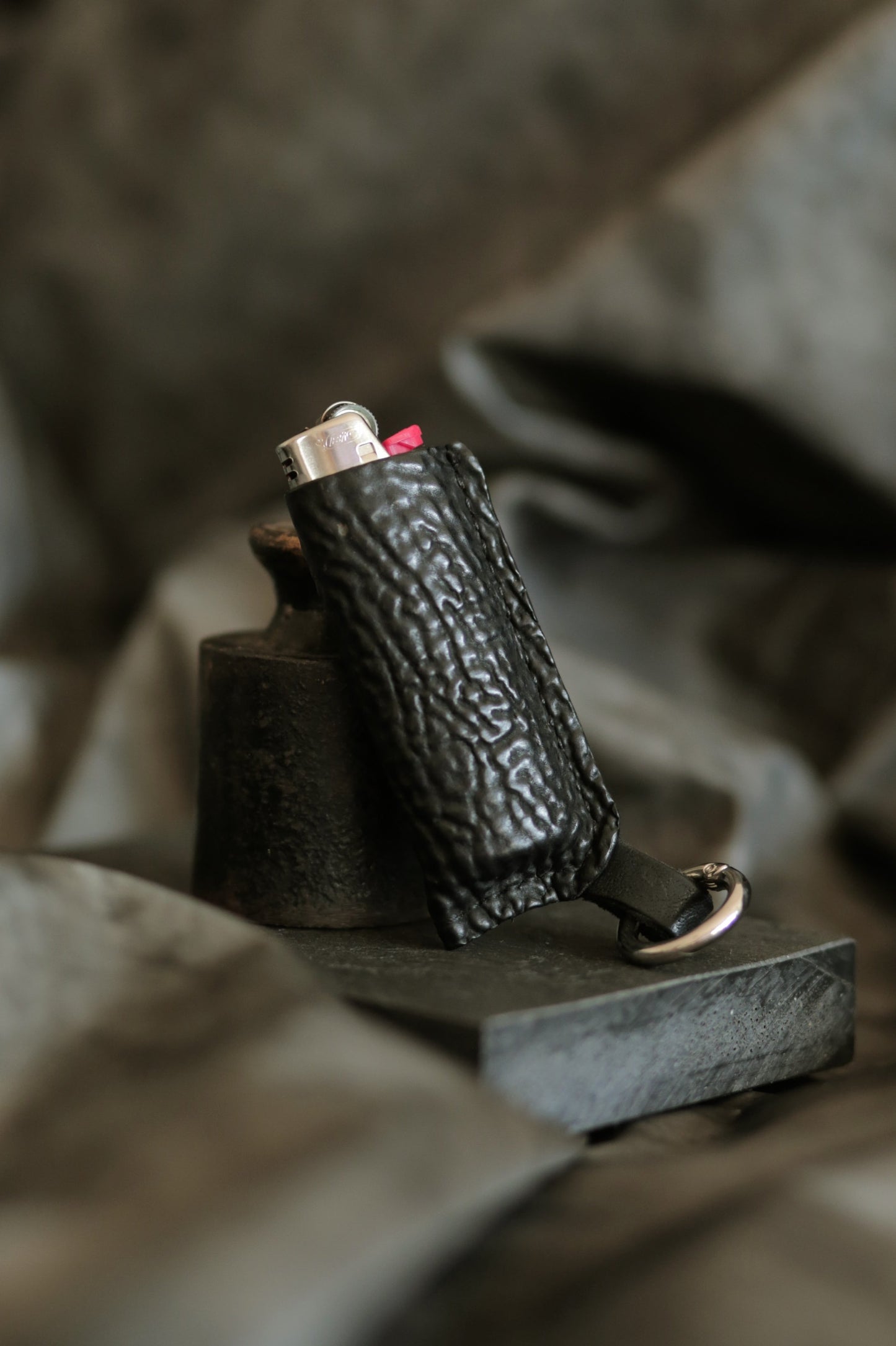 Lighter with black horse culatta leather case.