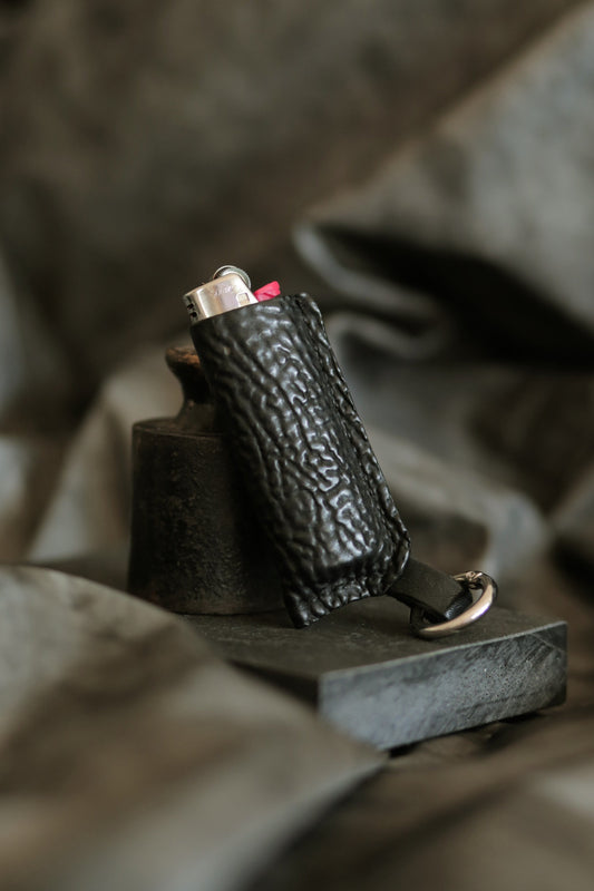 Lighter with black horse culatta leather case.